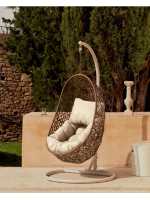 CULT suspended armchair in woven rattan with steel frame and and cushions included for indoor or outdoor